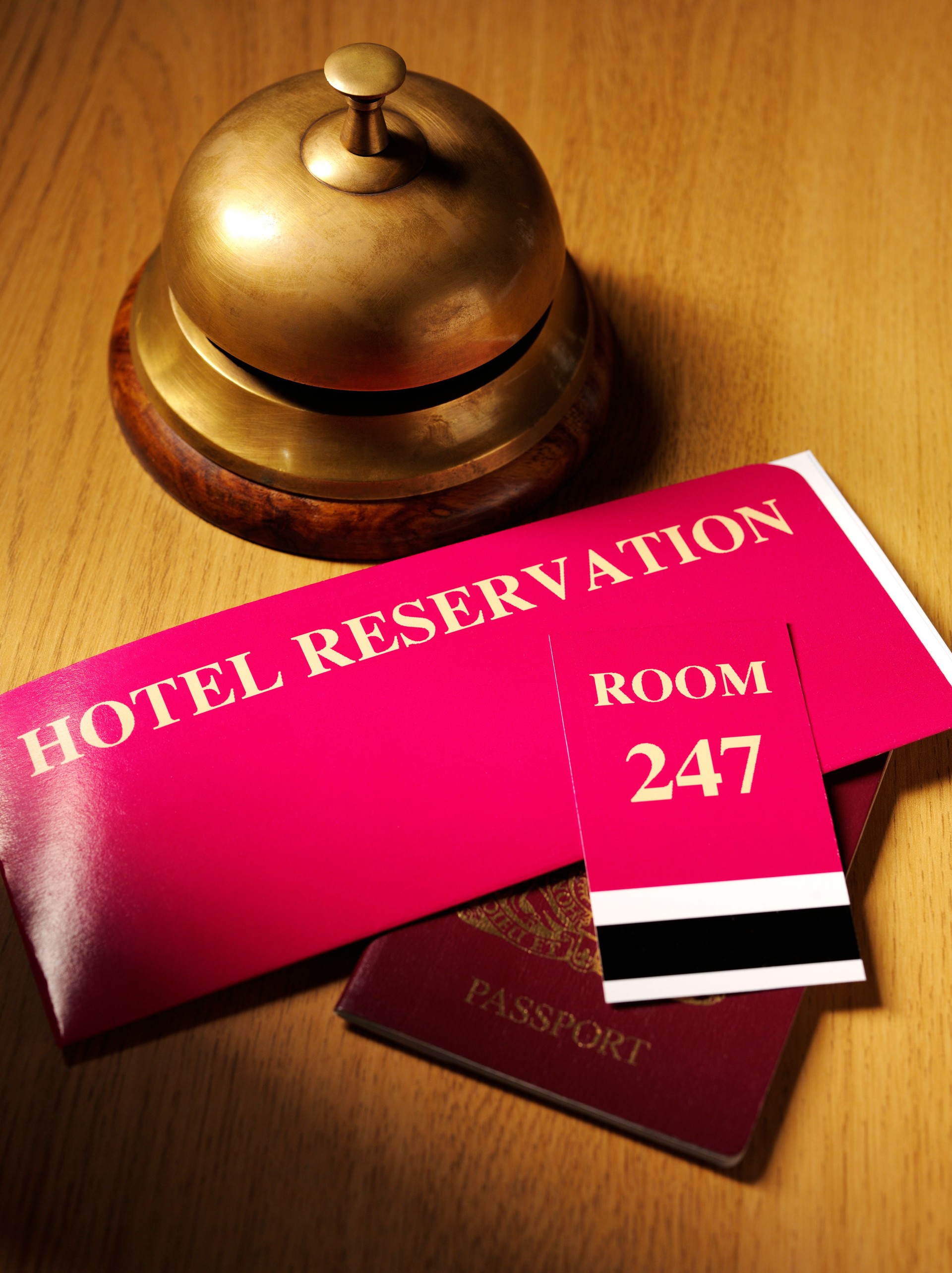 Hotel Reservation Ticket with a Passport by the Concierge Bell